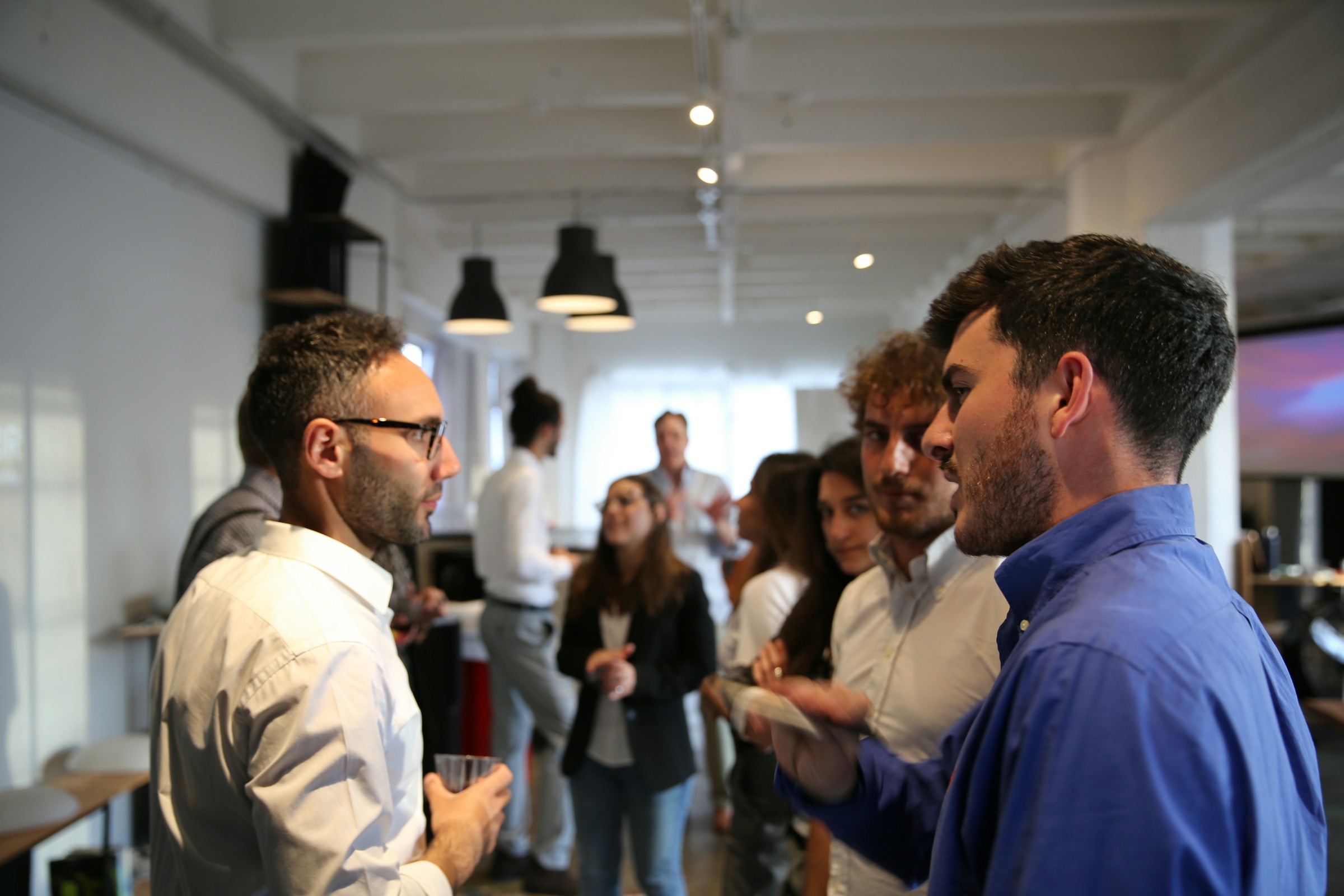Colleagues meeting and chatting at a company gathering
